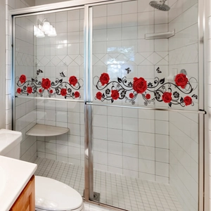 Detail of red rose and butterfly glass wall decals on a sliding shower door