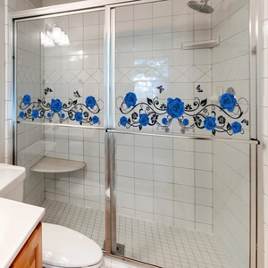 Detailed blue rose and butterfly vinyl decal applied on glass shower door panel
