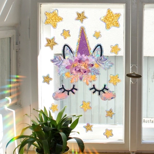 Detail of glitter unicorn window decals with floral ears and gold star stickers