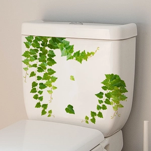 Detail of ivy green plant wall stickers applied on white toilet tank for bathroom decor