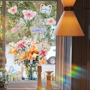 Holographic butterfly and floral window stickers creating rainbow sunlight refraction