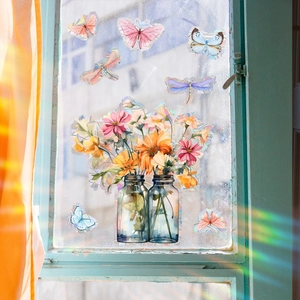 Rainbow effect detail of floral and butterfly static window clings on glass surface