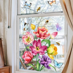 Detailed view of colorful tulip window clings with butterflies on a clear glass surface