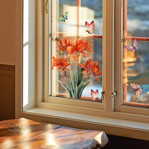 Detail of vibrant orange lilies and colorful butterfly window stickers on a white wooden frame