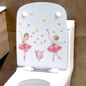 Cartoon ballet girls and pink swan wall decals on a clean white bathroom toilet lid