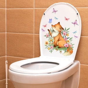 Detailed view of a watercolor fox and butterfly decal on a white toilet lid cover