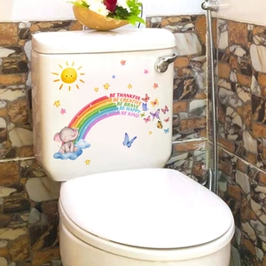 Close-up of elephant and rainbow bathroom stickers with inspirational phrases on a tank