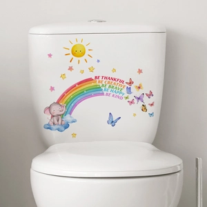 Detail of colorful cartoon elephant and rainbow decals on white bathroom surface
