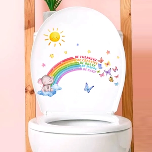 Detailed view of cute cartoon elephant and rainbow decals applied to a white toilet lid