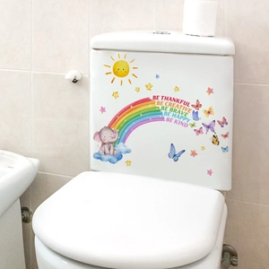 Detail of cartoon elephant and rainbow waterproof stickers on a white toilet tank