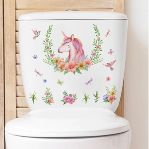 Close-up of unicorn and floral wall stickers applied on a white ceramic toilet tank