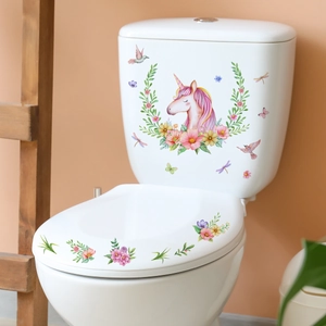Detailed view of colorful unicorn and floral decals on a white ceramic toilet