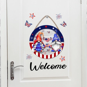 Detailed view of Independence Day gnome door sign with Welcome stickers on a white door