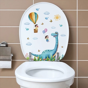 Detail of colorful cartoon dinosaur and hot air balloon wall decals on a white toilet lid