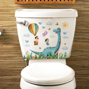 Cartoon dinosaur and hot air balloon stickers on a white ceramic toilet tank in bathroom