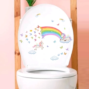 Close-up of waterproof cartoon unicorn and rainbow decals on a white ceramic toilet lid