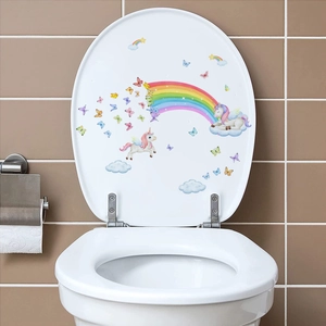 Detailed view of colorful unicorn and rainbow decals on a white bathroom toilet lid