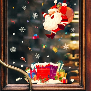 Detail of Santa Claus and snowflake static stickers on a glass window with festive lights