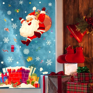 Detailed view of Santa and snowflake window clings with festive gift box decorations
