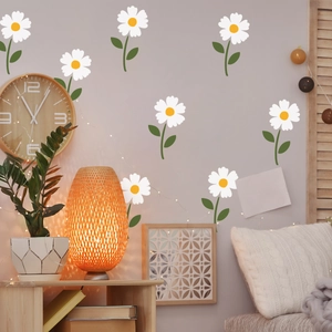 Minimalist white daisy flower wall decals for home decor shown on a grey living room wall