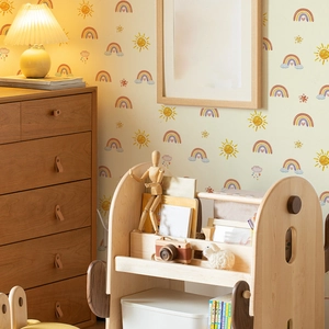 Minimalist sun and rainbow wall sticker for nursery decor in a cozy kids room setting