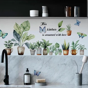 Detail of kitchen wall sticker with green plants, butterflies and seasoned with love quote