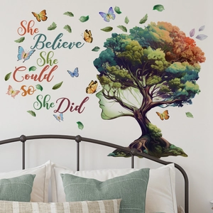 Bedroom wall decor featuring a colorful tree wall decal with butterflies and inspirational text
