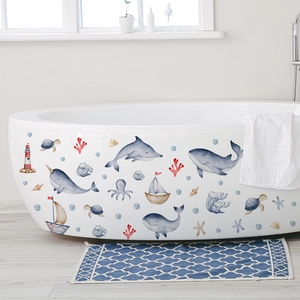 Watercolor ocean animals wall stickers applied to a white bathtub in a bright bathroom