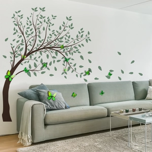 Modern wall sticker set featuring a large brown tree and green butterflies in a living room