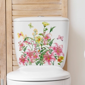 Floral butterfly wall decals on white ceramic toilet tank with pink lilies and yellow daisies