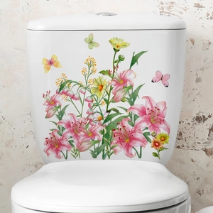 Detail of floral butterfly wall stickers with pink lilies on a white toilet tank