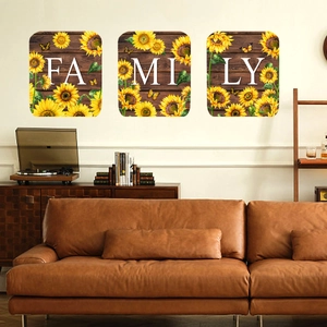 Detailed view of 3-piece FAMILY sunflower wall stickers on a dark wood grain background