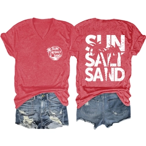 Detail view of women's red V-neck T-shirt with Sun Salt Sand print and denim shorts