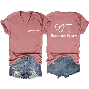 Flat lay of dusty rose Occupational Therapy V-neck shirt and distressed denim shorts