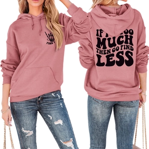 Detail view of pink oversized hoodie showing back slogan print and front pocket