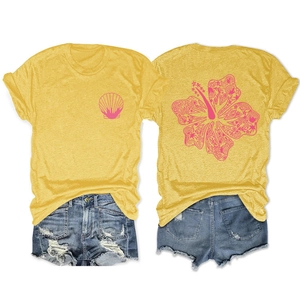 Macro detail of tropical yellow T-shirt with pink hibiscus and starfish print on back
