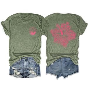 Flat lay of olive green T-shirt with pink hibiscus print and distressed denim shorts