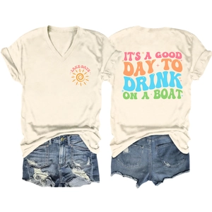 Flat lay of cream V-neck t-shirt with Lake Days print and distressed denim shorts