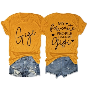 Flat lay of mustard yellow T-shirt with Gigi graphic print and distressed denim shorts