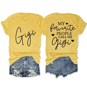 Flat lay view of a bright yellow graphic T-shirt and distressed denim shorts outfit set