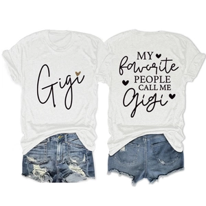 Detail of white Gigi graphic t-shirt with heart print and blue distressed denim shorts