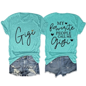 Detailed view of turquoise Gigi T-shirt back with slogan and distressed denim shorts