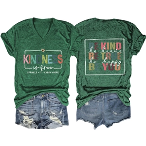 Flat lay of green V-neck T-shirt with kindness slogan and ripped denim shorts