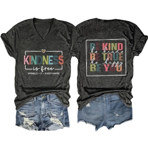 Detail of V-neck grey T-shirt with kindness slogan and distressed denim shorts