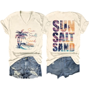 Flat lay of a beige V-neck T-shirt with Sun Salt Sand tropical print and denim shorts