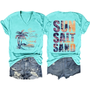 Flat lay of turquoise V-neck beach t-shirt with palm print and distressed denim shorts