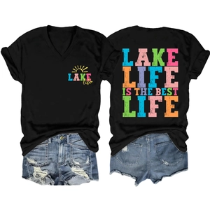 Flat lay of black V-neck Lake Life T-shirt and distressed denim shorts summer set