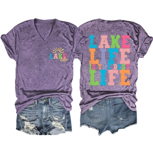 Flat lay of purple V-neck T-shirt with Lake Life sun print and distressed denim shorts