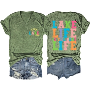 Flat lay of army green V-neck T-shirt with Lake Life print and distressed denim shorts
