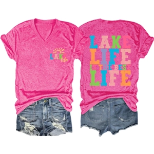 Flat lay of pink V-neck T-shirt with Lake Life prints and distressed denim shorts